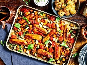 A traybake with Quorn Best of British Sausages, butternut squash, tomatoes, and courgette.